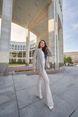 Pretty fashion female model with long legs. Pretty woman wearing casual clothes and posing in the city on a summer day