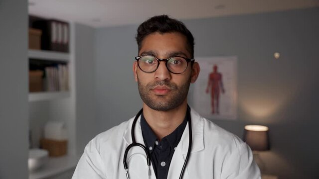Mixed race male doctor standing in office wearing stethoscope
