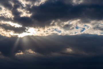 Obraz premium Rays of light shining throug dark clouds.Beautiful dramatic sky with sun rays.