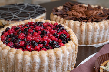Assorted fresh cakes on a dark table