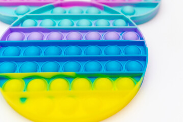 Color sensory pop it antistress toy for children. rainbow toy on white background.Pop it trendy toy.Copy space.