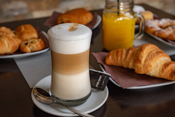 Breakfast with cappuccino, orange juice, croissant