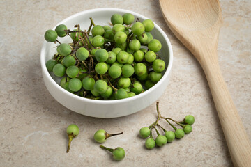 Bowl with green Thai eggplants close up 