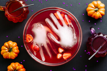 Happy Halloween holiday party composition. Flat lay bloody cocktail with frozen hands, pumpkins....