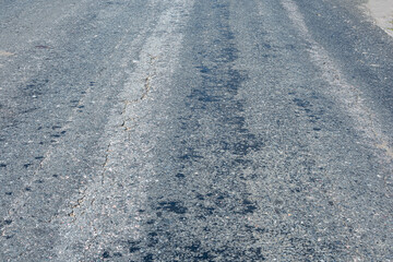 Old road surface on a hot summer day.