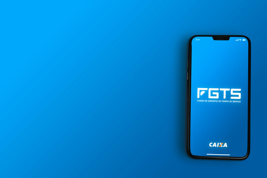 FGTS da Caixa app on smartphone screen on blue background. Brazilian worker guarantee fund. Top view. Rio de Janeiro, RJ, Brazil. May 2021.
