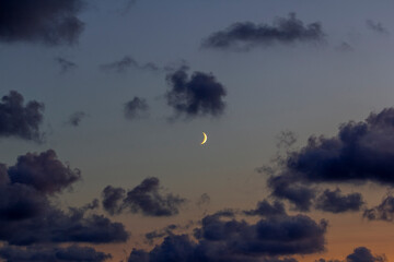 Sunset light, young moon and dark clouds, copy space. Baltic sea, Palanga Europa