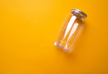 Fototapeta premium transparent plastic bottle on yellow background