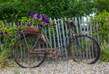 old vintage bicycle with basket on a wooden fence