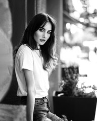 Woman sitting in white t-shirt in the city