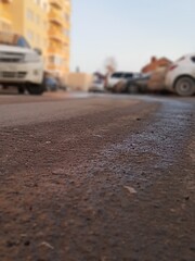 The road and traces of cars on the asphalt near the house