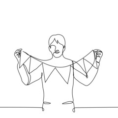 man stands smiling and holds in front of him a thread with a triangular flag - one line drawing. home decor concept (interior TO HOLIDAY