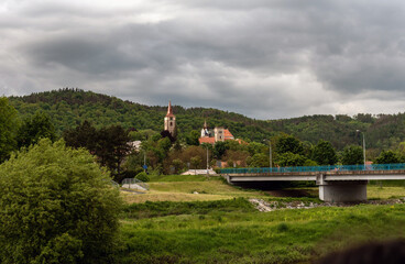 blue bridge over the river and the tower of the monastery