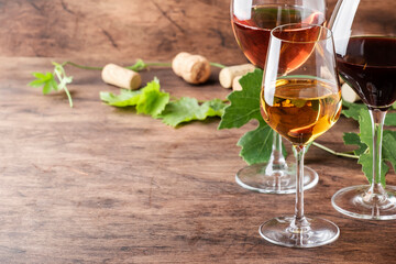 Wine tasting. Red, white, rose- still wines sin glasses on vintage wooden table background