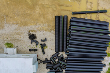 Stacked, polyethylene pipe pile temporarily at a new construction building