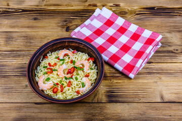 Instant noodle with shrimps, red pepper and green onion in a ceramic bowl. Japanese food
