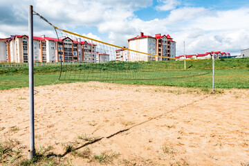 Fototapeta na wymiar Volleyball court with net on sand near river.