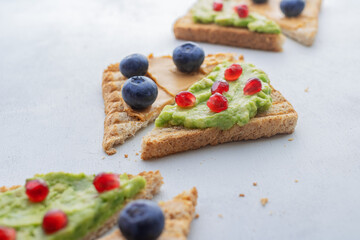 Colorful Sandwiches. Healthy sandwiches. Healthy lifestyle. Sandwiches with peanut butter and blueberries. Avocado and pomegranate toast. Slimming.