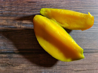 Slice of mango. Mango cutaway. Mango background. Ripe fresh mango.