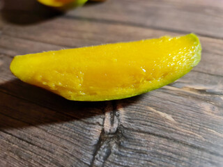 Slice of mango. Mango cutaway. Mango background. Ripe fresh mango.