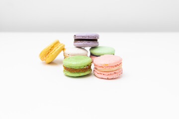 macaroons in different colours on a withe table