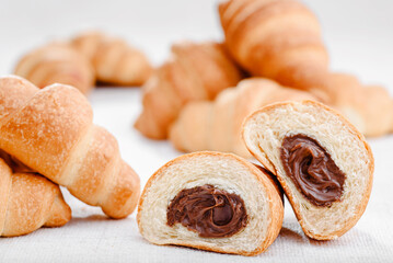 Lots of mini croissants with chocolate isolated on white background. Banner. Space for text. High quality photo