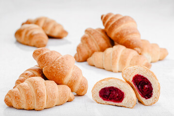Lots of mini croissants with cherries isolated on white background. Banner. High quality photo