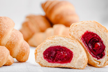Lots of mini croissants with cherries isolated on white background. Banner. High quality photo