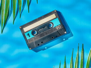 Vintage audio cassette on blue background