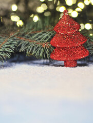 Christmas tree decoration in pine tree on lights background. Festive christmas background.	