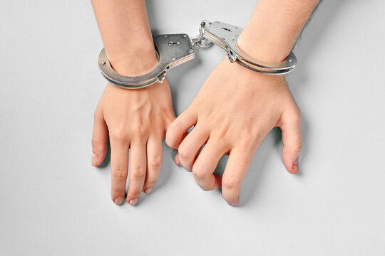 Male and female hands in handcuffs. Love forever.