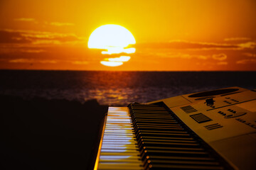 Synthesizer on the background of the sunset