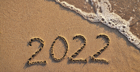  Inscription 2022 on the beach, new year 2022 concept.