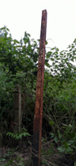 Fototapeta premium Rusty iron pillars on the side of the road