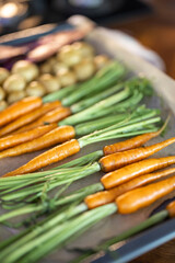 Fresh baked root vegetables on the tray. Concept of fresh locally grown seasonal vegetables