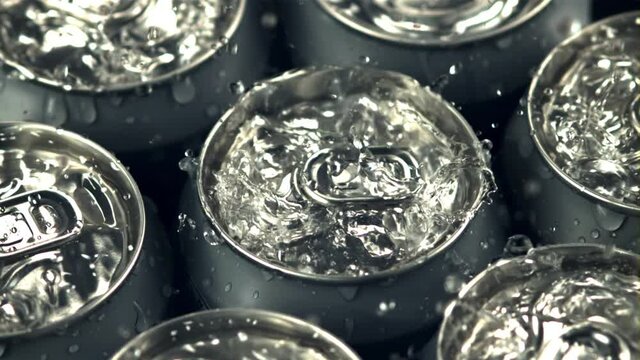 Super slow motion on tins with beer drop drops of water with spray. Macro background. Filmed on a high-speed camera at 1000 fps.High quality FullHD footage