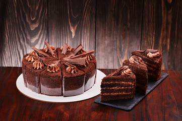 Chocolate cake on a dark wooden background. Space for text. High quality photo