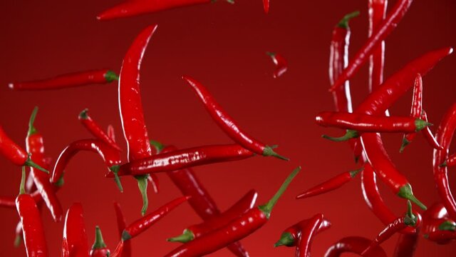 Super slow motion of flying various kinds of chilli peppers. Filmed on high speed cinema camera, 1000 fps. Speed ramp effect.