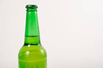 green glass bottle covered with water drops. condensate
