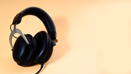 black headphones on a uniform background, a copy of the design space