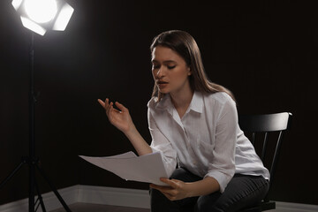 Professional actress reading her script during rehearsal in theatre - obrazy, fototapety, plakaty
