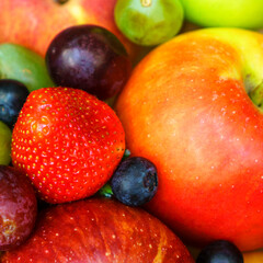 Summer fruit, berry assortment. Big apple, plum, apricot, grape and strawberry. Colorful berries in wooden crate on the table.
