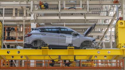 Car Production line. Assembling cars at conveyor assembly line. Modern Assembly of cars at the plant. The automated build process of the car body. Industrial concept.