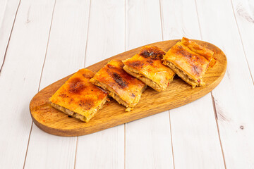 Pieces of Galician empanada cut into squares stuffed with tuna stew sprinkled with paprika