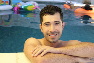 Young man relaxing in swimming pool 