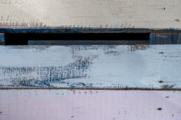 Image of unpolished planks painted with pastel blue, pink and yellow chalk paint