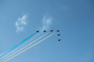 Group of aircrafts  flying with color smoke in blue sky under the Kiev during the parade on the occasion of 30 years of independence of Ukraine, august 2021