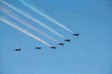 Group of aircrafts  flying with color smoke in blue sky under the Kiev during the parade on the occasion of 30 years of independence of Ukraine, august 2021