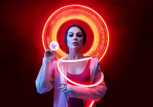 Beautiful woman in futuristic costume on dark background. Augmented reality, future technology, AI concept. Holographic interface to display data. Red neon light.