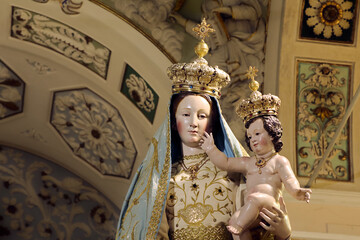 Close up of the Statue of the Virgin "Santa Maria delle Grazie" inside the homonymous Sanctuary in Torre di Ruggiero (Calabria, Italy). The inscription "Ave Maria" (Hail Mary) is visibile on the niche